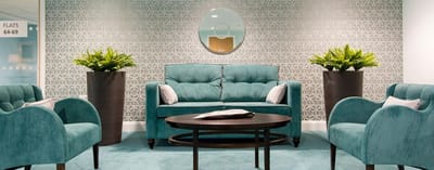 Interior common area with teal furnishings and plants
