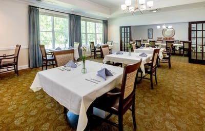 Dining room with elegantly set tables and natural light