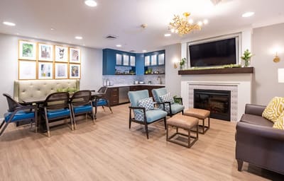Bright common area with seating and fireplace