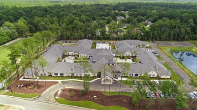 Aerial view of Sage Lake Senior Living facility surrounded by trees