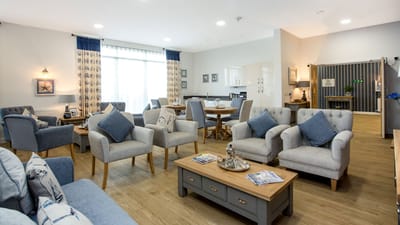 Bright common area with comfortable seating in a retirement facility