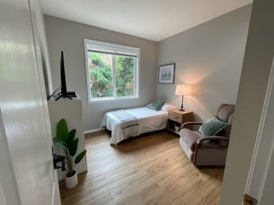 Cozy resident room with a bed and chair