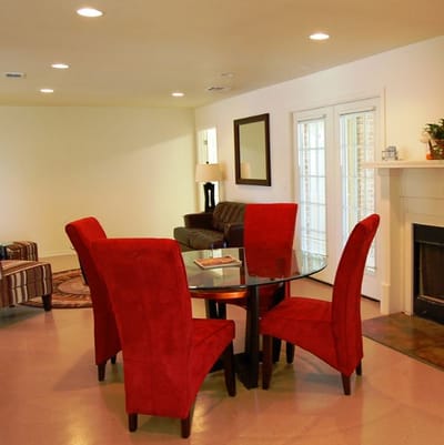 Bright common area with red chairs and a table