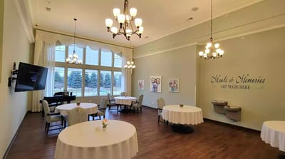 Bright dining room with tables and artwork