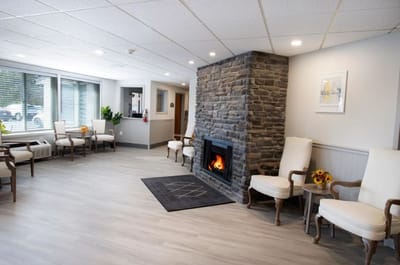 Bright common area with seating and a fireplace