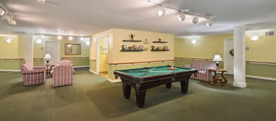 Interior common area with a pool table and comfortable seating