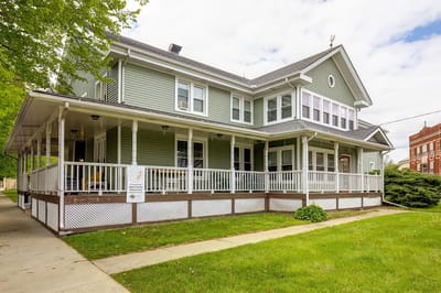 Beautiful exterior view of a senior living facility with porch