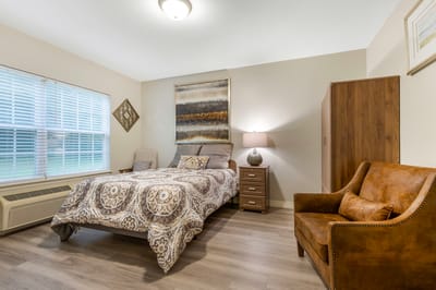 Private resident room with a bed and chair
