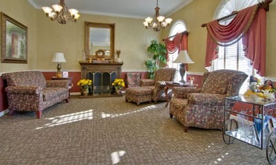 Cozy common area with floral furniture and fireplace