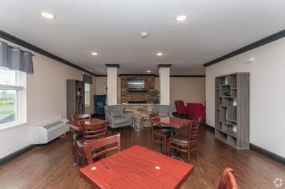 Bright common area with seating and a TV