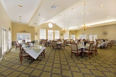Dining room with tables and chairs arranged for meals