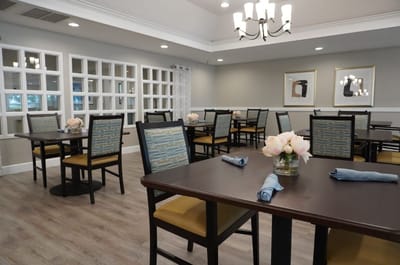 Bright dining room with tables set for meals