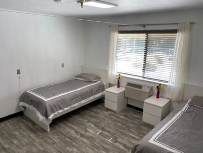 Private resident room with two beds and decorative flowers