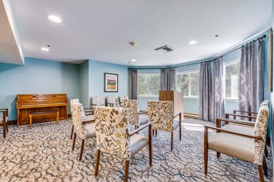 Bright common area with seating and piano