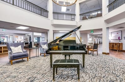 Common area with a piano and seating for residents