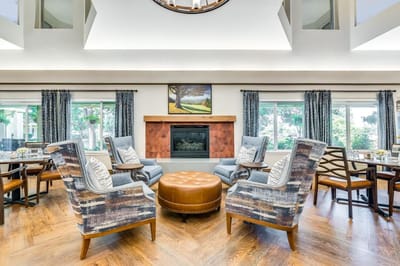Bright common area with seating around a fireplace