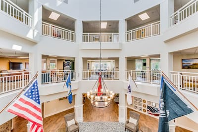Interior view of a bright common area with flags