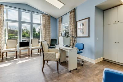 Bright common area with large windows and seating