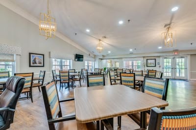 Bright dining room with multiple tables and chairs