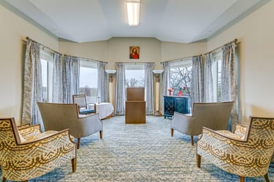 Bright common area with seating and large windows