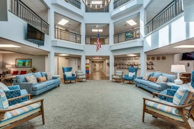 Bright common area with comfortable seating and gray carpeting