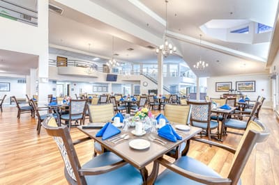Bright dining room with tables set for a meal