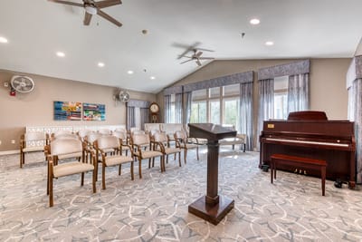 Bright common area with seating and a piano