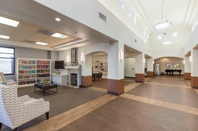 Bright and welcoming common area with seating and bookshelves