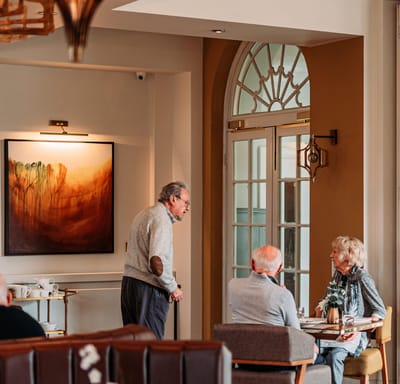 Residents conversing in a facility interior