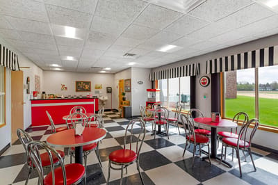 Interior of a dining room with red tables and chairs
