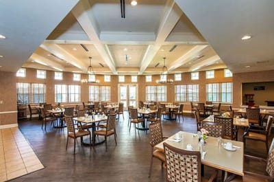 Bright dining room with tables set for residents