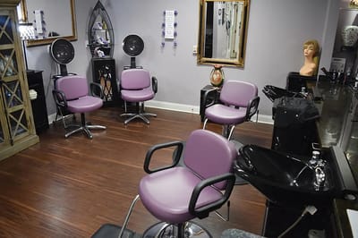 Interior of a hair salon with styling chairs and mirrors