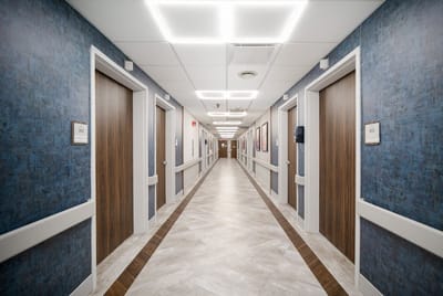 Interior hallway with resident rooms in a healthcare facility