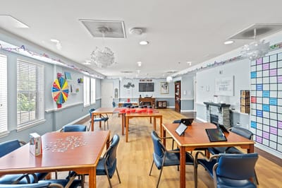 Bright communal activity room with tables and games