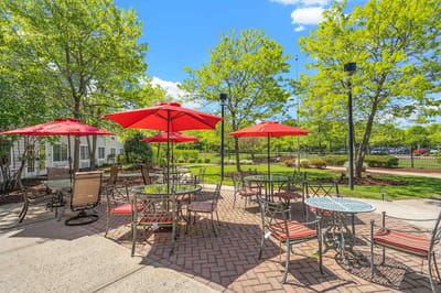 Outdoor patio area with tables and umbrellas
