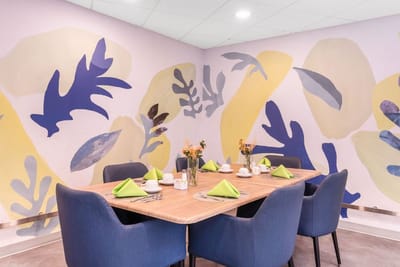 Dining room set for a meal with decorative walls