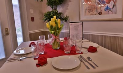 A beautifully set dining table with flowers