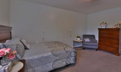 Cozy private resident room with bed and furniture