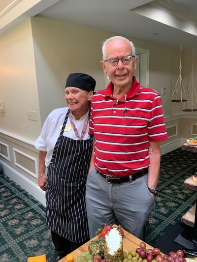 Chef and resident smiling together in the facility