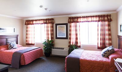 Cozy resident room with two beds and natural light