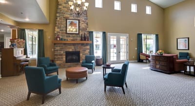 Bright common area with seating and a fireplace