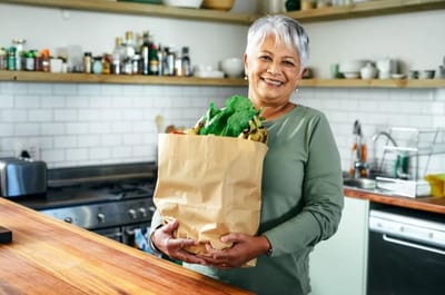 Stoney Brook of Copperas Cove, assisted living in Copperas Cove, TX — Smiling woman holding a grocery bag in a kitchen