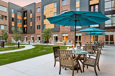 Outdoor seating area with tables and umbrellas