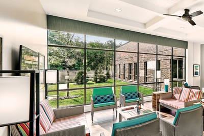 Bright common area with seating and large windows