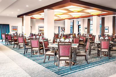 Bright dining room with tables set for meals