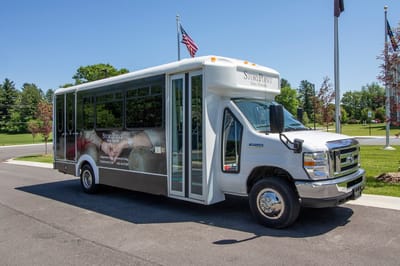 Facility transport bus parked at the entrance