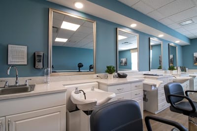 Interior of a salon with styling stations and mirrors