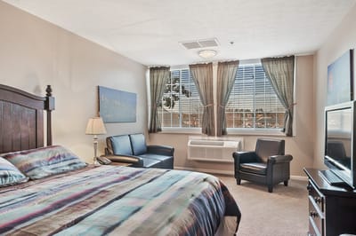 Comfortable resident room with a double bed and seating area