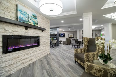 Interior view of a cozy common area with seating and fireplace