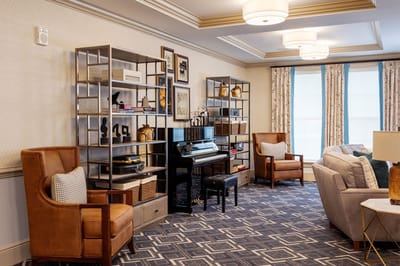 A warm common area with seating and shelves